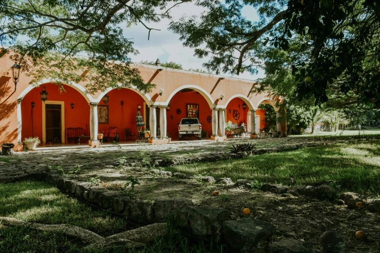 red house with several trees and benches outside