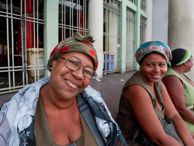 a smiling woman and another women sitting next to each other