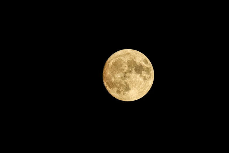 a plane flying by with the moon behind it