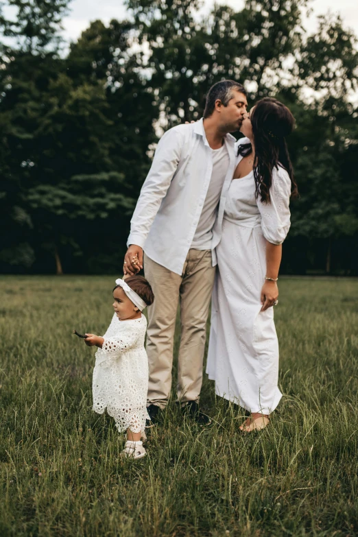 a family is posing for a po in a field