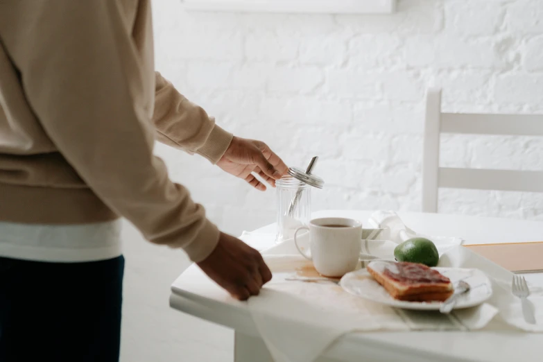 a person is setting a plate with food on it