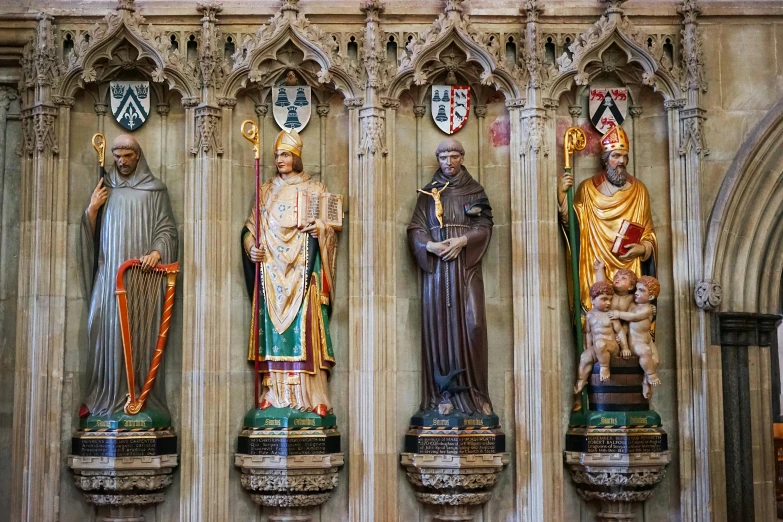 a group of statues with ornate carvings next to each other