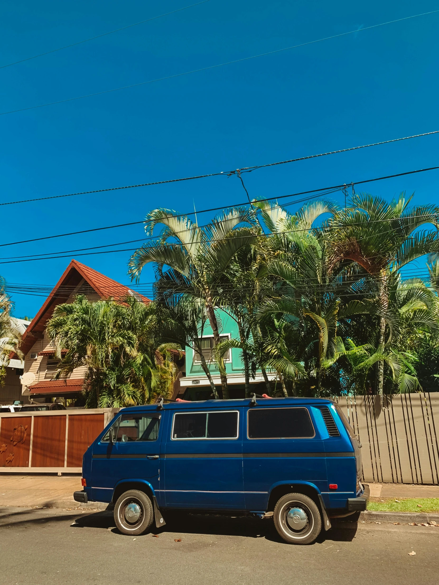 a blue van is parked on the side of the street