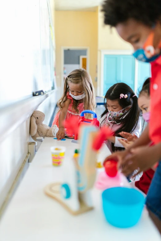 children work together on a craft project in an assembly facility