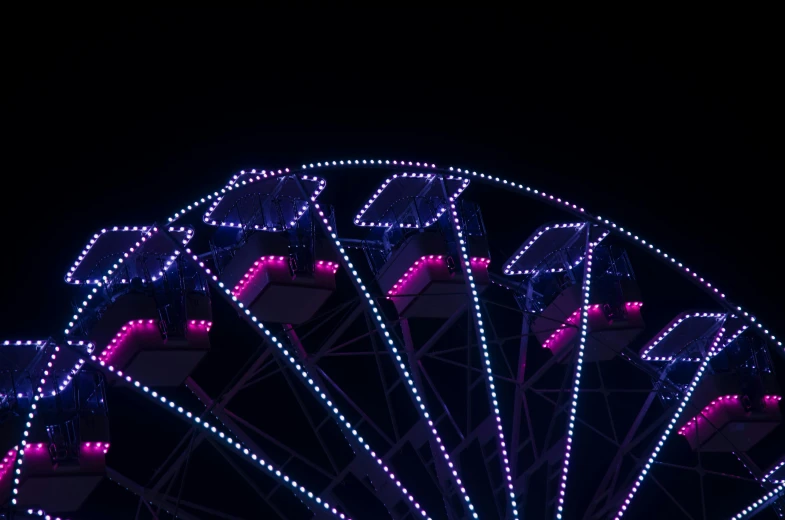 a ferris wheel is lit up with christmas lights