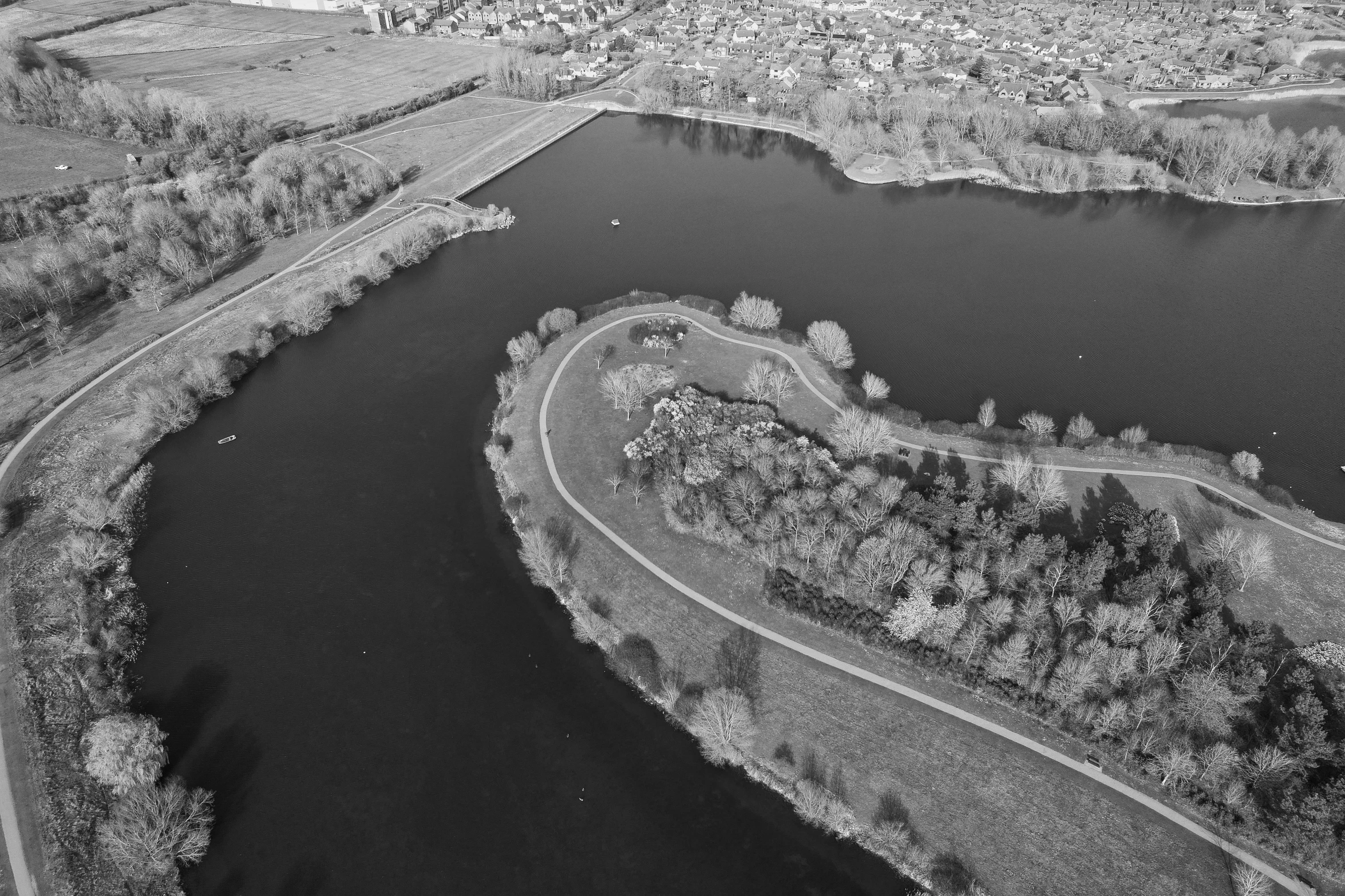 an aerial view of a lake that's surrounded by trees