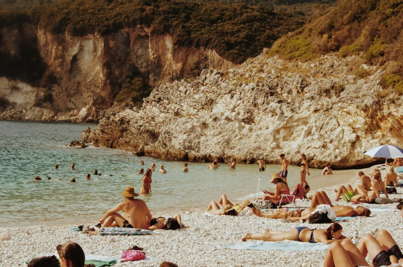 people are on the beach with their umbrellas up