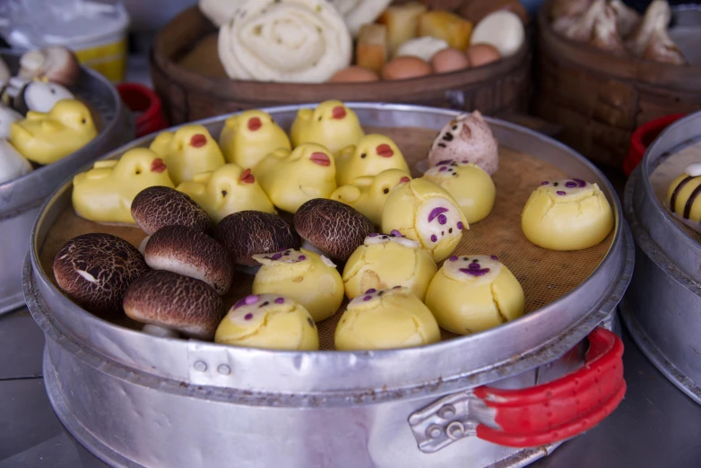 several plates holding tiny toy mushrooms in varying colors