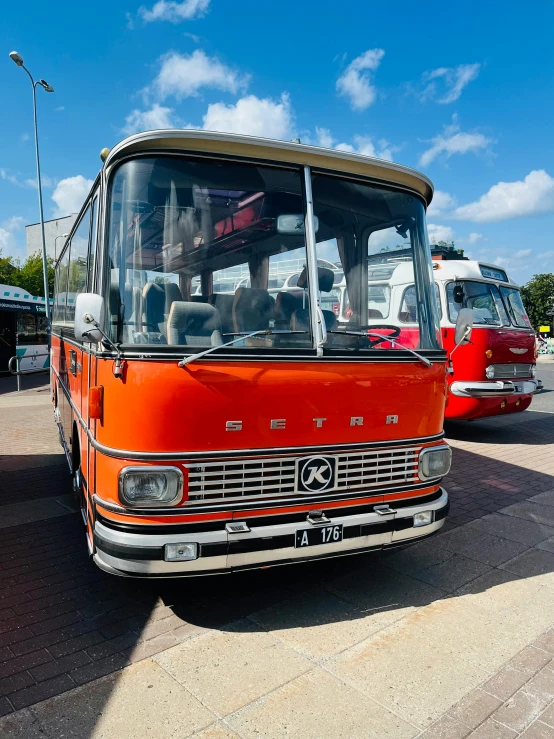 a orange bus parked on the side of a road