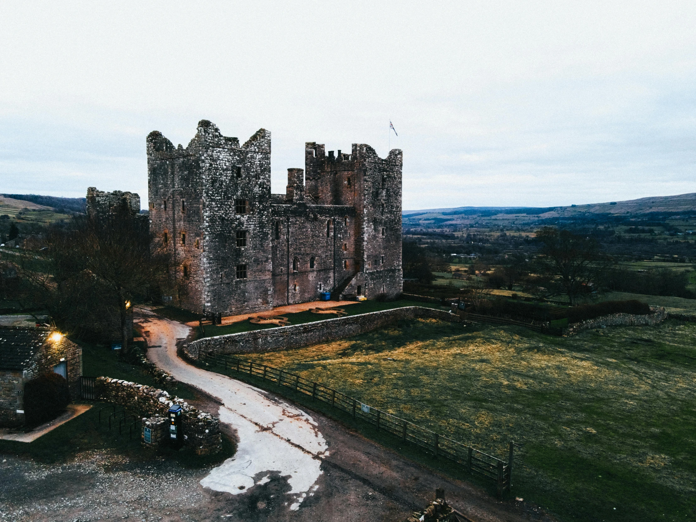 a large castle in the middle of a green field