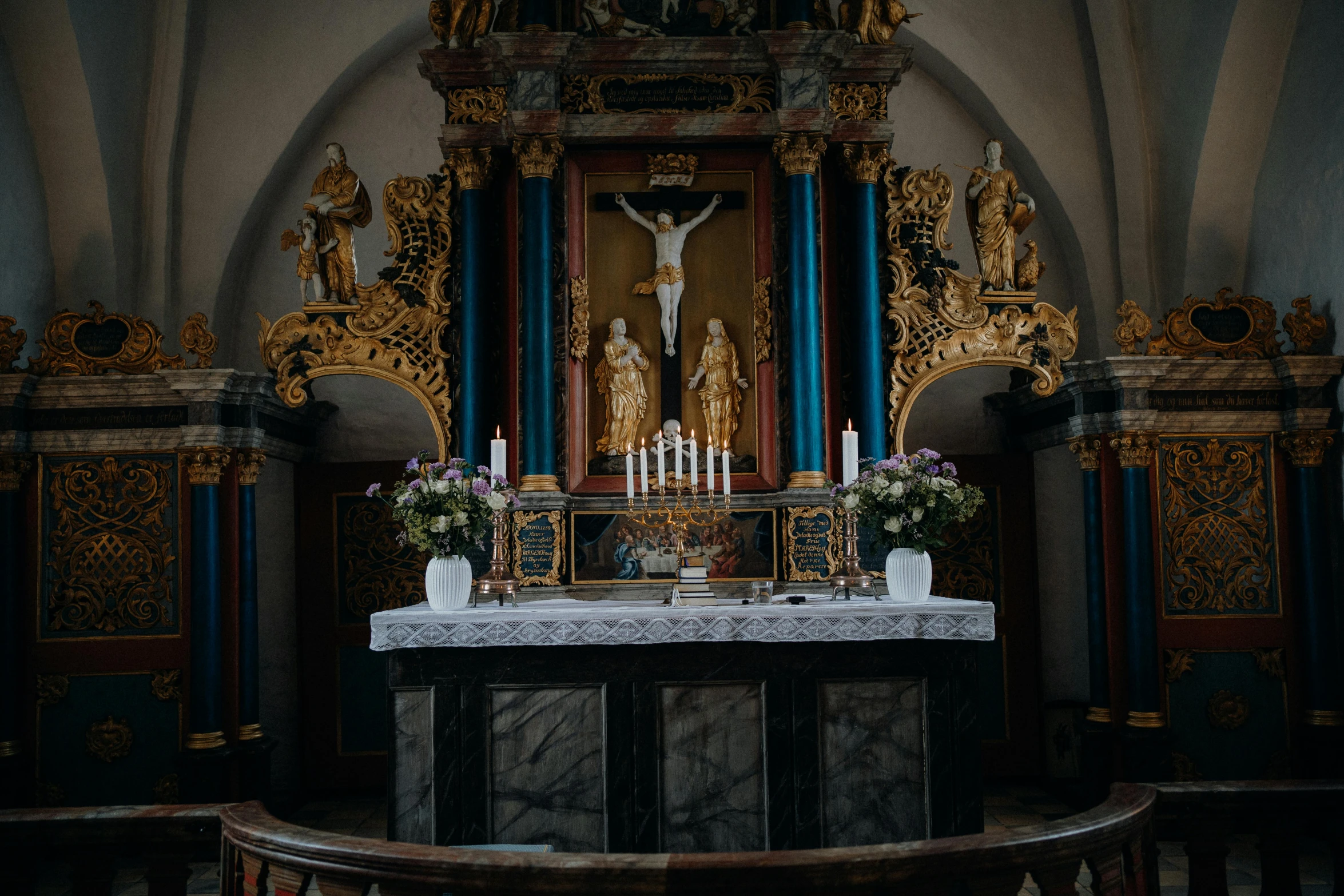 inside of an old church, with ornate and gilded pews