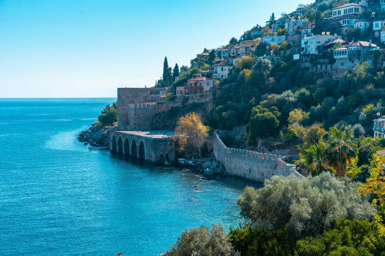 a hillside with houses on it on a hillside next to the water