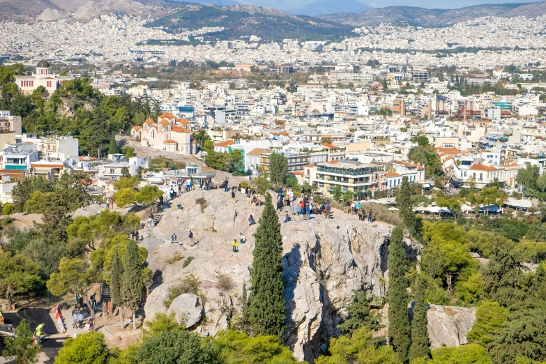 a city is surrounded by hills and trees