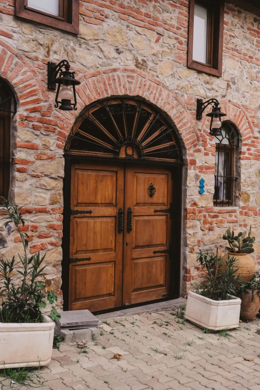 an arched door sits in front of a brick house