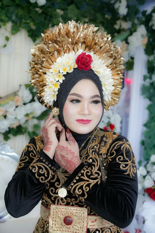 a person dressed in oriental style clothing with flower on her head