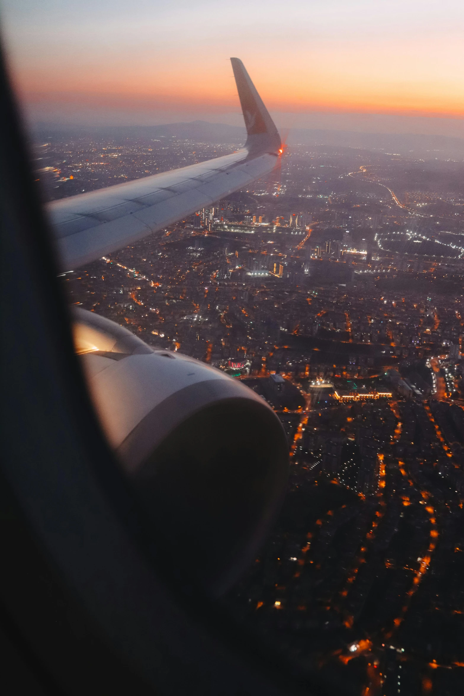 view from an airplane window as the sun sets