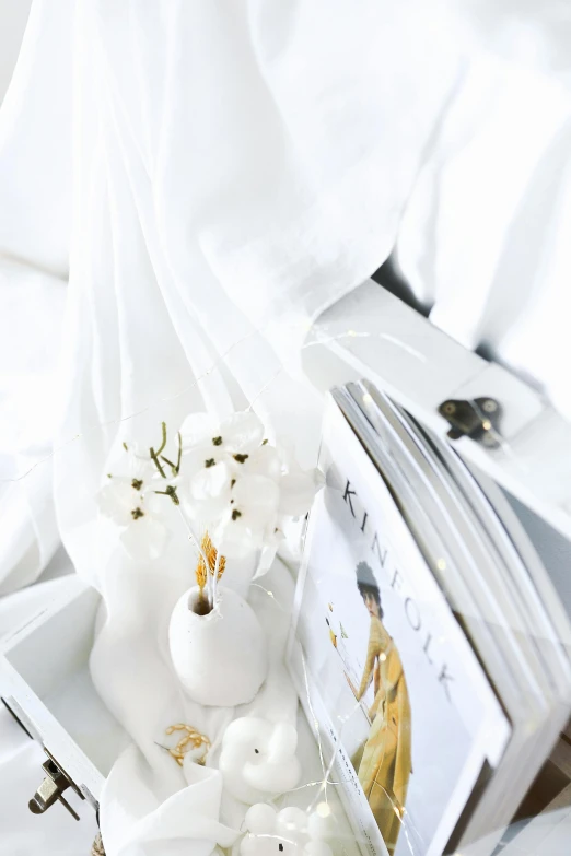 a bed with a white and gold decorated box on it