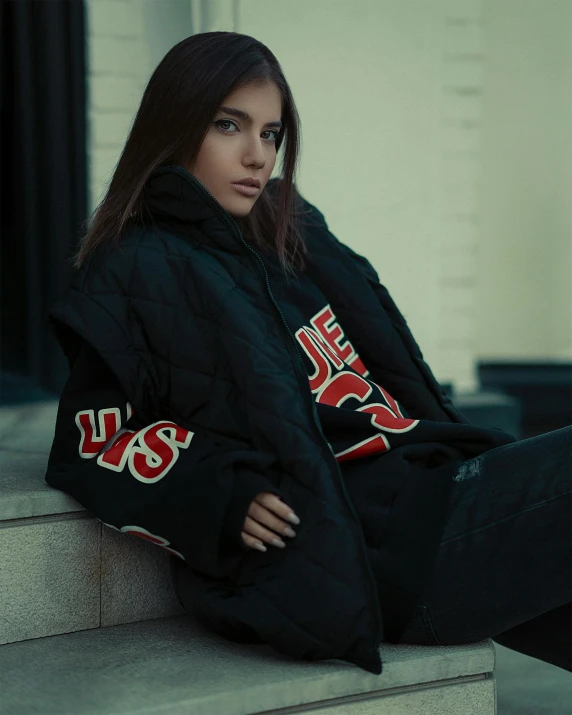 a woman sitting on the ground with her legs crossed