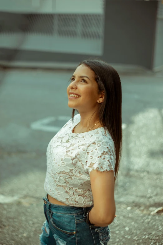 woman in a white shirt smiling outside