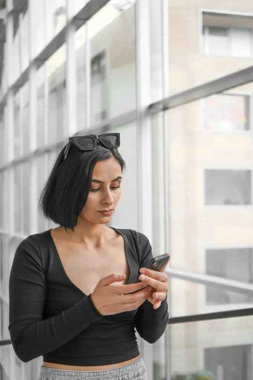 a woman holding and looking at her phone