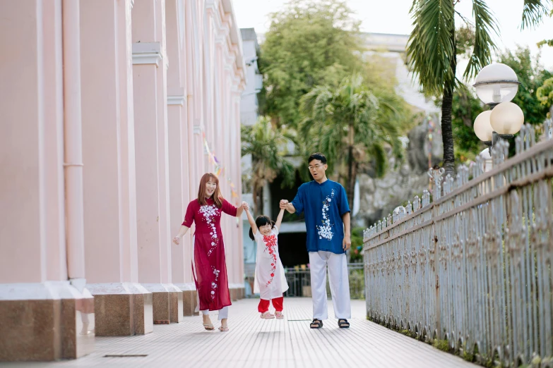 a man and two small children walking on the sidewalk