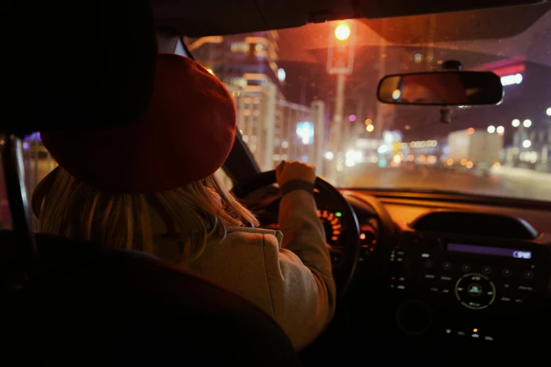 woman driving in the dark at night, with a car on the other side