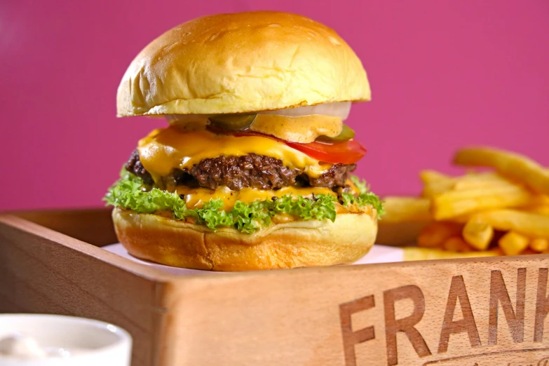 a hamburger and fries in a wooden box