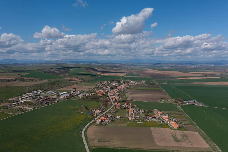 a village and some fields taken from an airplane