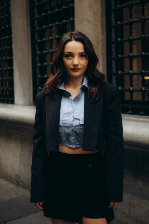 a woman in a black jacket and shirt posing