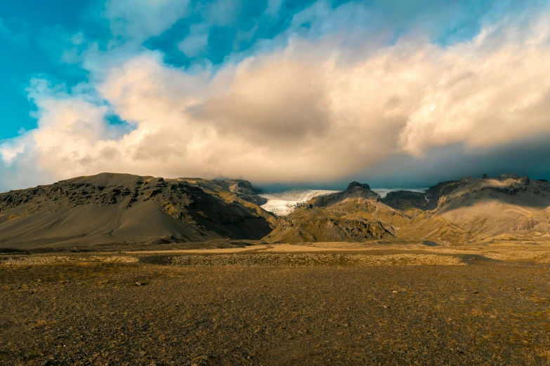 a vast mountain range is pographed during a cloudy day