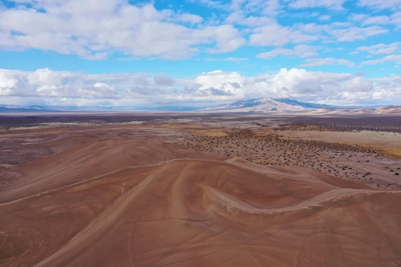 an aerial view of some barren plains with clouds