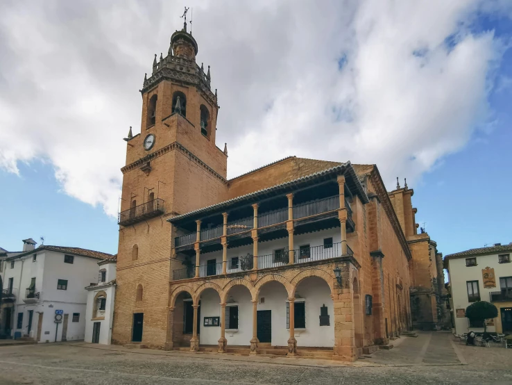 an old building with two large windows and a tower