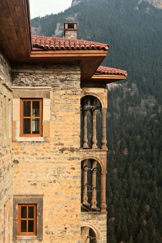 an old building with two windows overlooking a valley