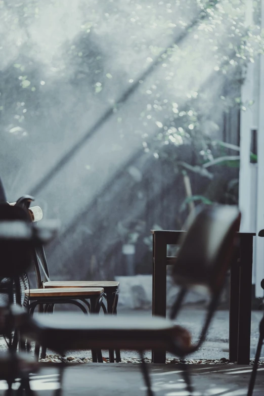 an open window with a chair and two chairs