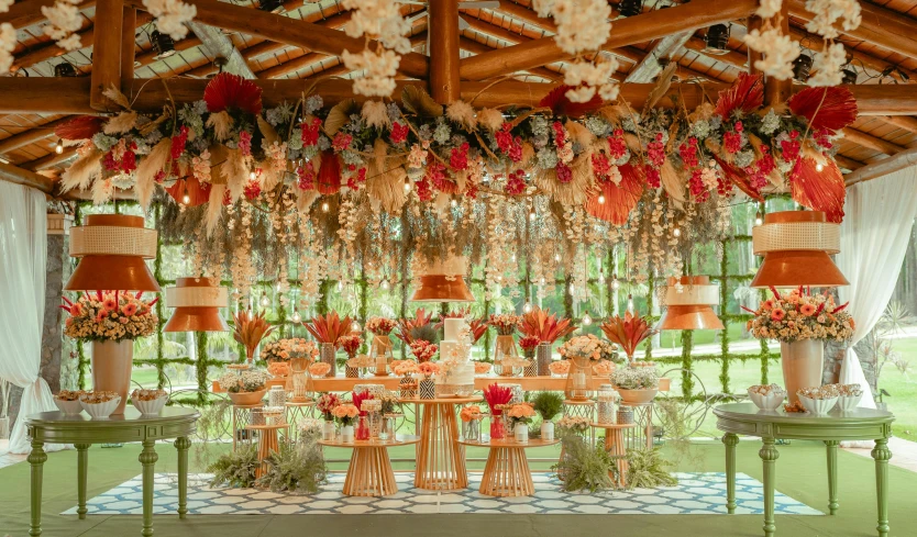 many flowers hanging down from a wooden structure