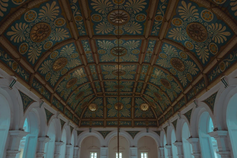 ornate ceiling with decorative panels and gold accents