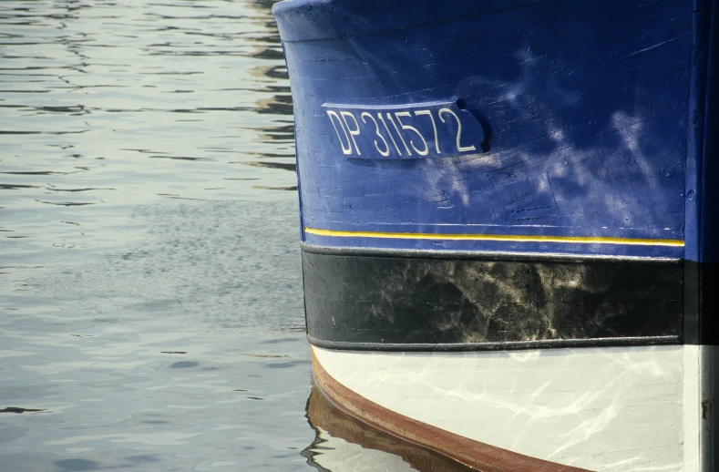 the back end of a boat floating in a lake