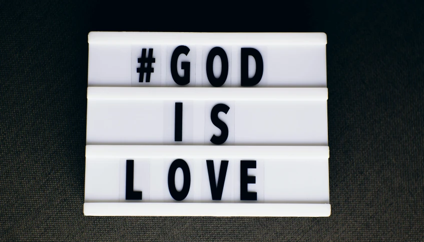 the word god is love written on four blocks