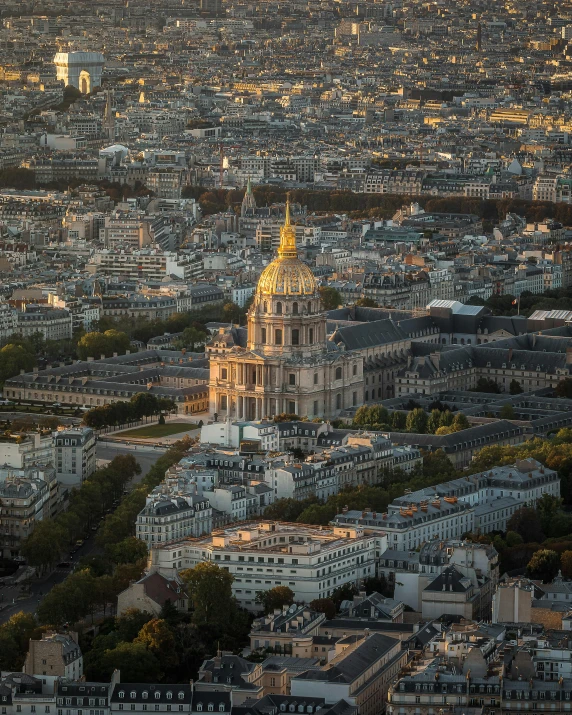 the sun setting on a large old church on the hillside of paris