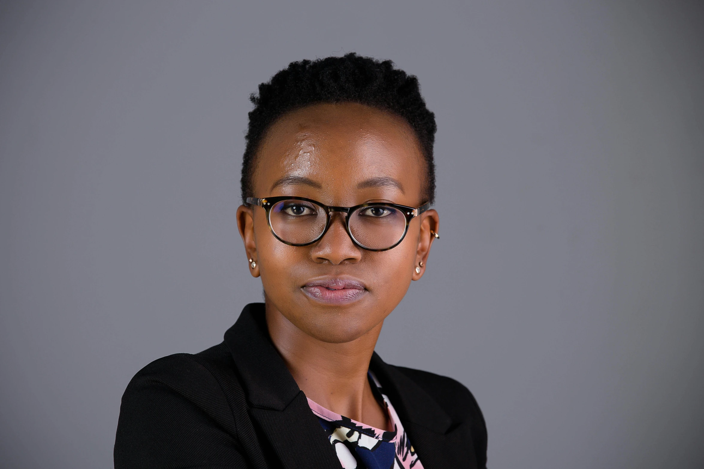 a woman is wearing glasses and is posing