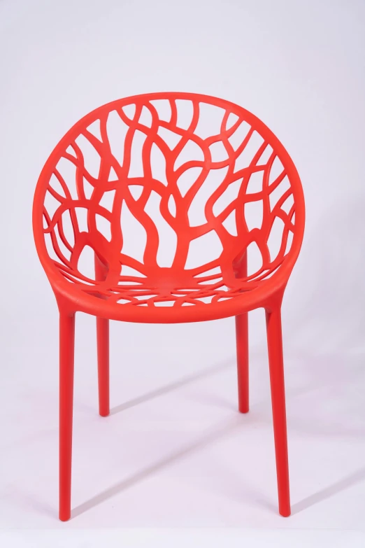a red stool that has a circular, intricate design on it