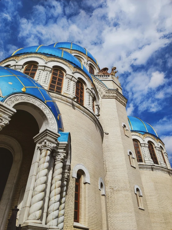 there is a very tall cathedral with blue and yellow on it