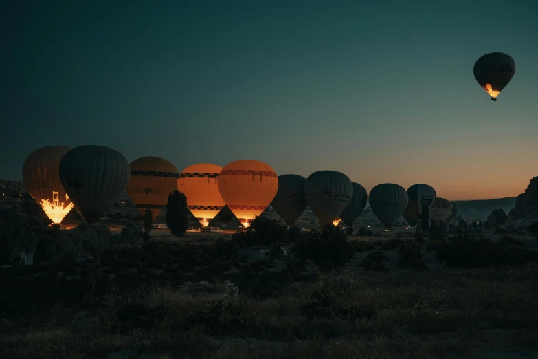 several  air balloons in the night sky