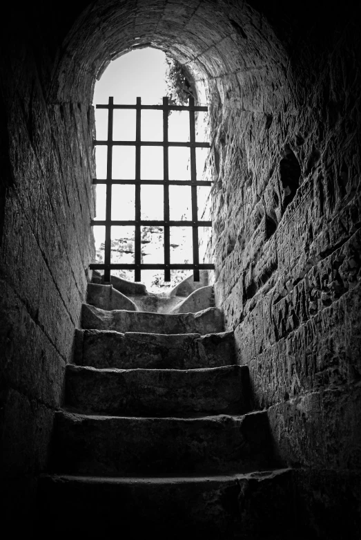 some stairs leading up to a window in a stone wall