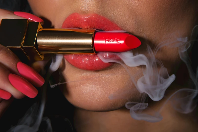 a woman with red lipstick smoking a lipstick