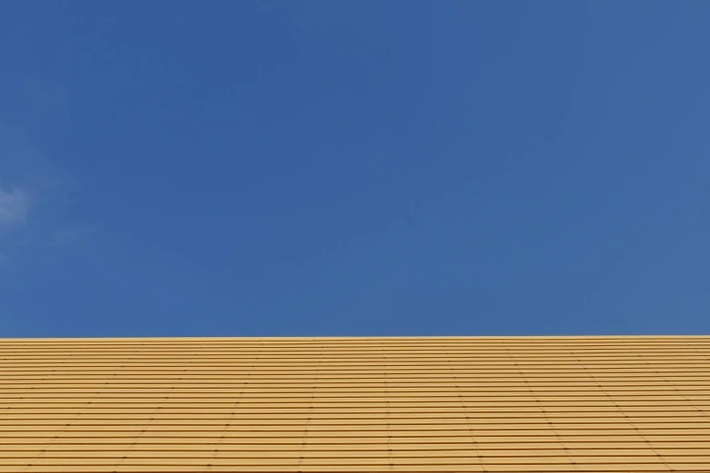 a yellow roof with a clock on it