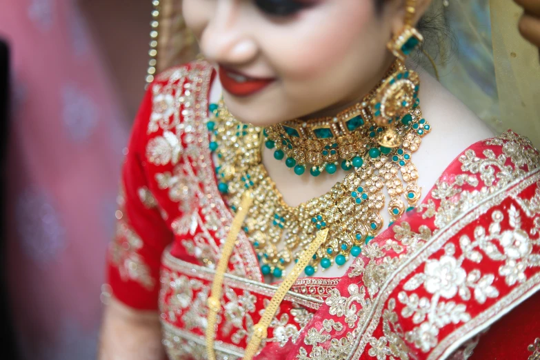 the bride is in red and gold attire