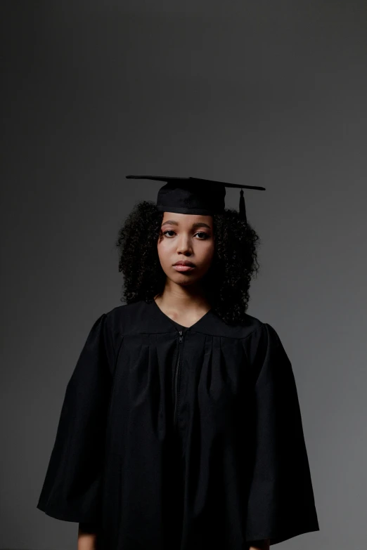 a child wearing a graduation cap and gown