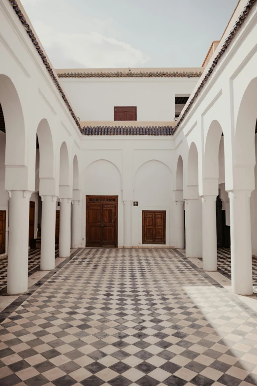 this is a large building with arches and a checkerboard floor