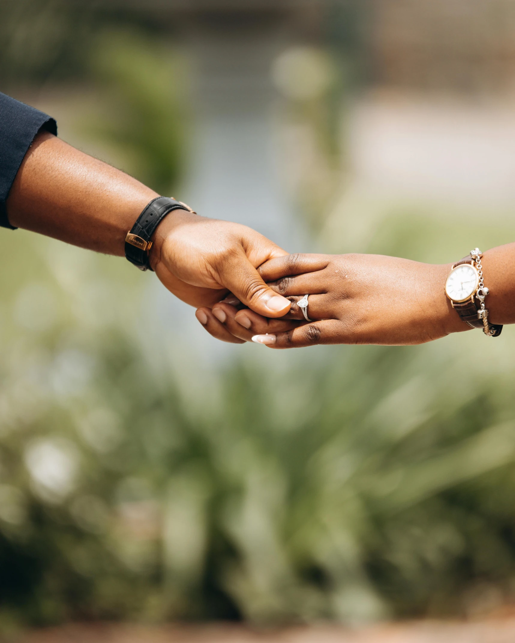 people hold hands close up and smile